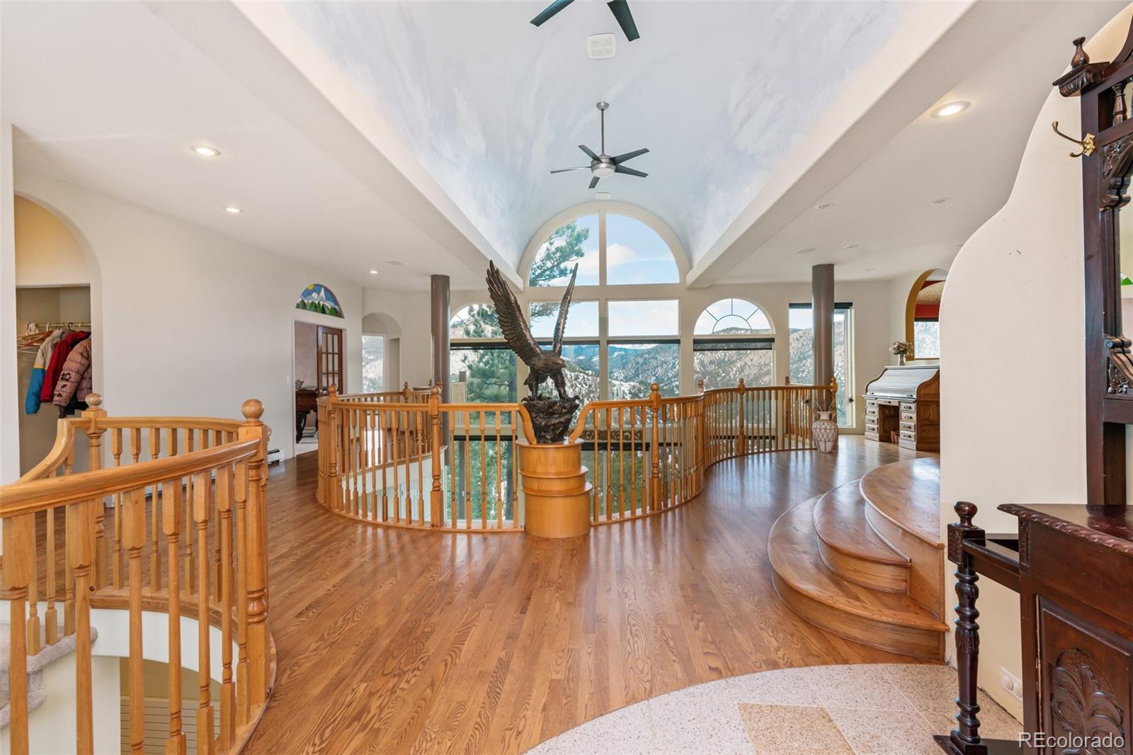 323 Overlook Lane Boulder, CO 80302 - Photo 2 of 40 a living room with lots of wooden furniture and a chandelier