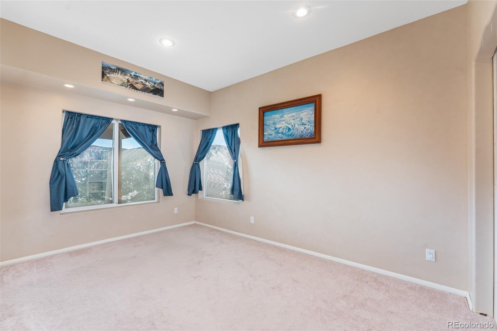 323 Overlook Lane Boulder, CO 80302 - Photo 22 of 40 an empty room with windows and fan