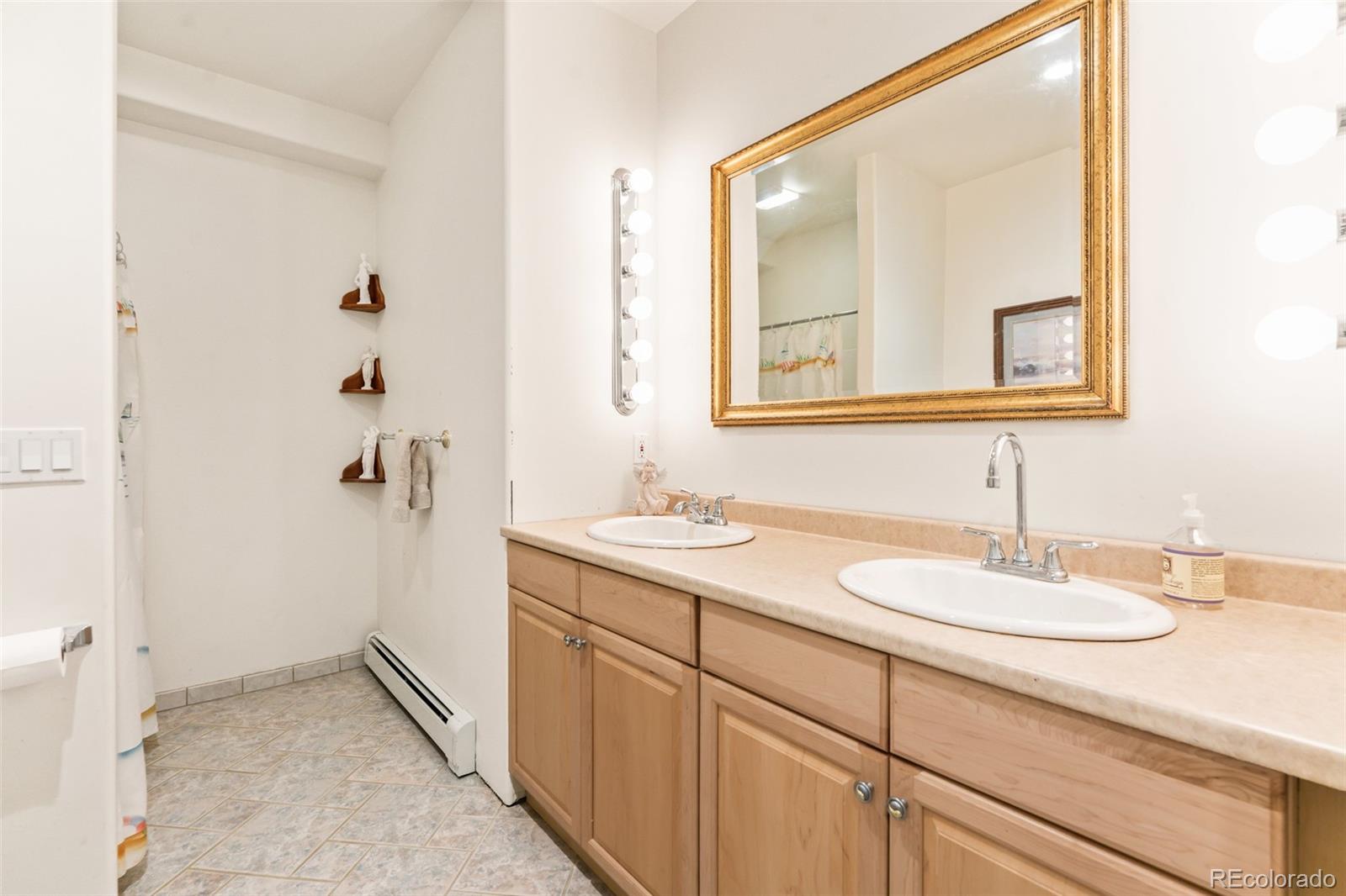 323 Overlook Lane Boulder, CO 80302 - Photo 25 of 40 a bathroom with a sink and a mirror