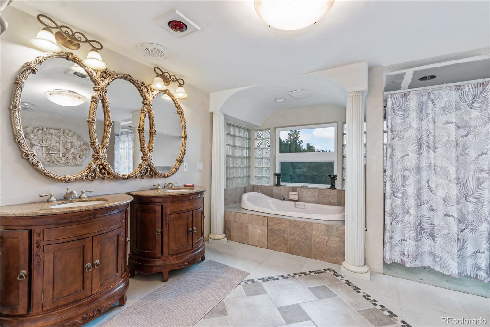 323 Overlook Lane Boulder, CO 80302 - Photo 31 of 40 a spacious bathroom with a granite countertop tub sink and mirror