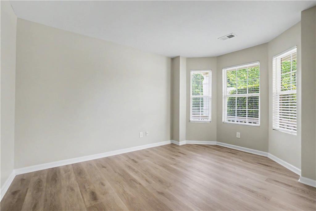 375 Walton View Fairburn, GA 30213 - Photo 6 of 38 a view of empty room with wooden floor and fan