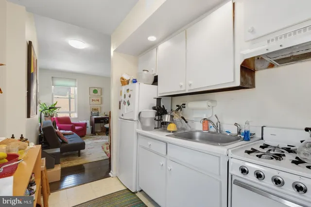a kitchen with stainless steel appliances a stove a sink and cabinets