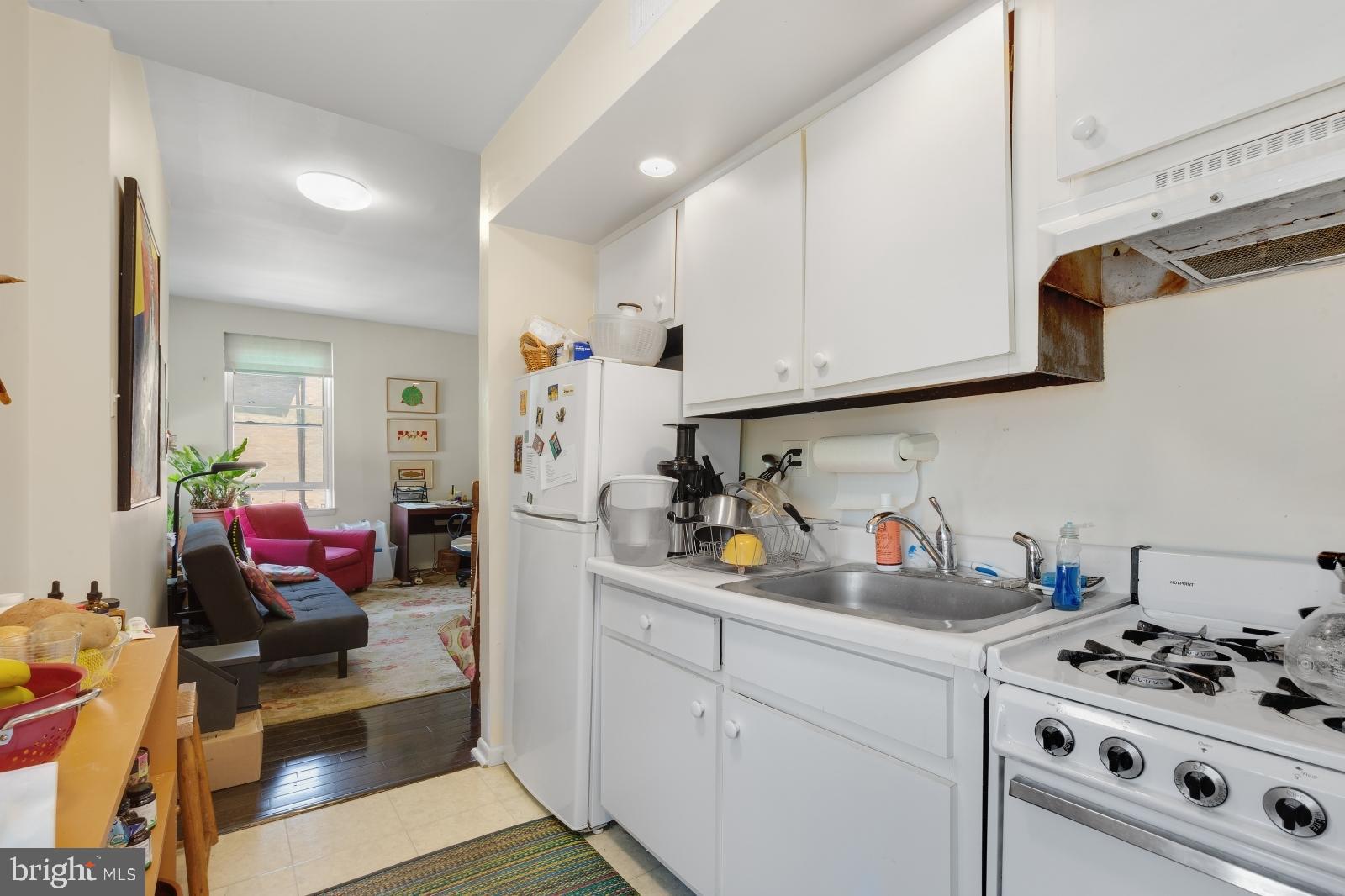 2137 Spruce Street, Unit 8 Philadelphia, PA 19103 - Photo 4 of 12 a kitchen with stainless steel appliances a stove a sink and cabinets