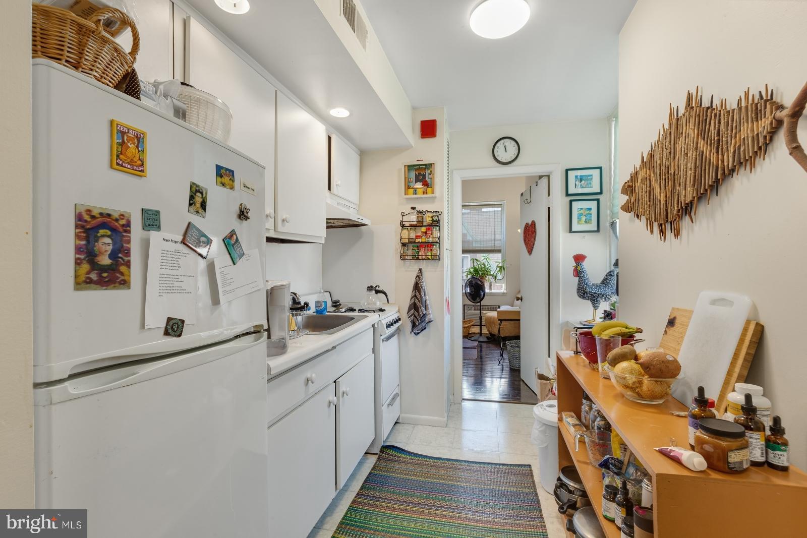 2137 Spruce Street, Unit 8 Philadelphia, PA 19103 - Photo 5 of 12 a kitchen with stainless steel appliances a refrigerator and a wooden floor