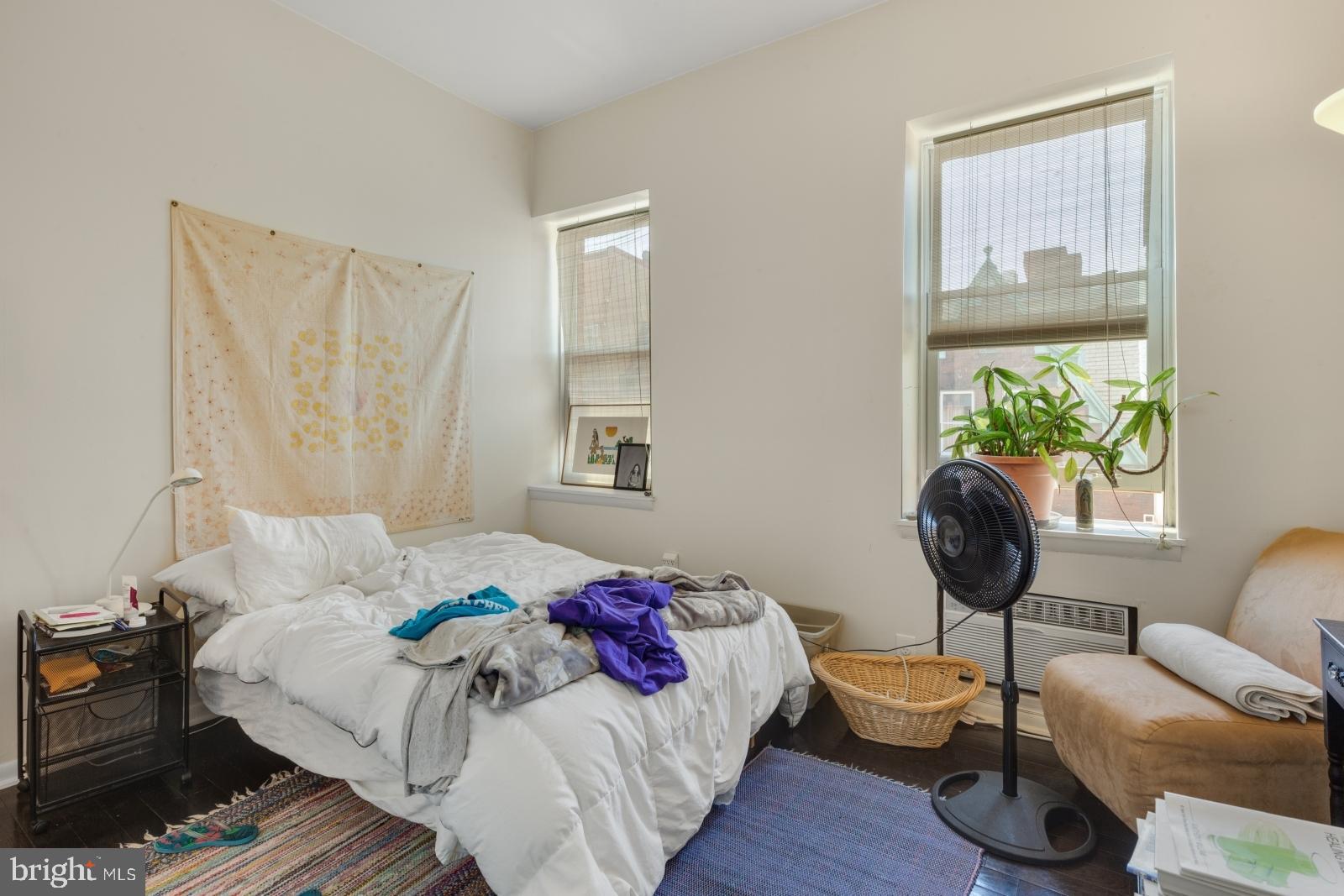 2137 Spruce Street, Unit 8 Philadelphia, PA 19103 - Photo 6 of 12 a bedroom with a bed and wooden floor