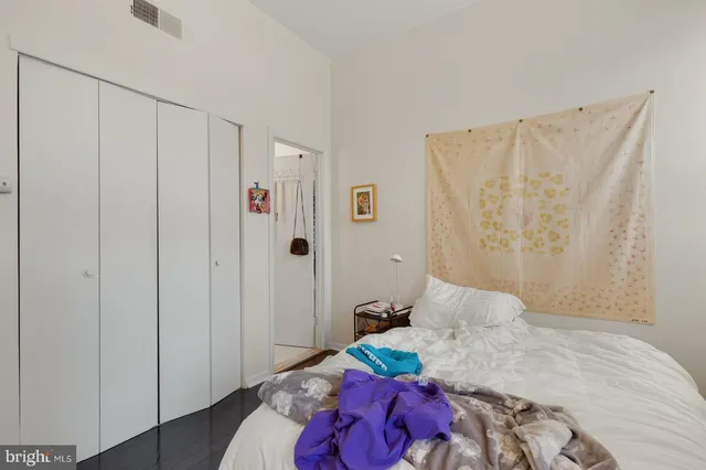 a bedroom with a bed and a closet