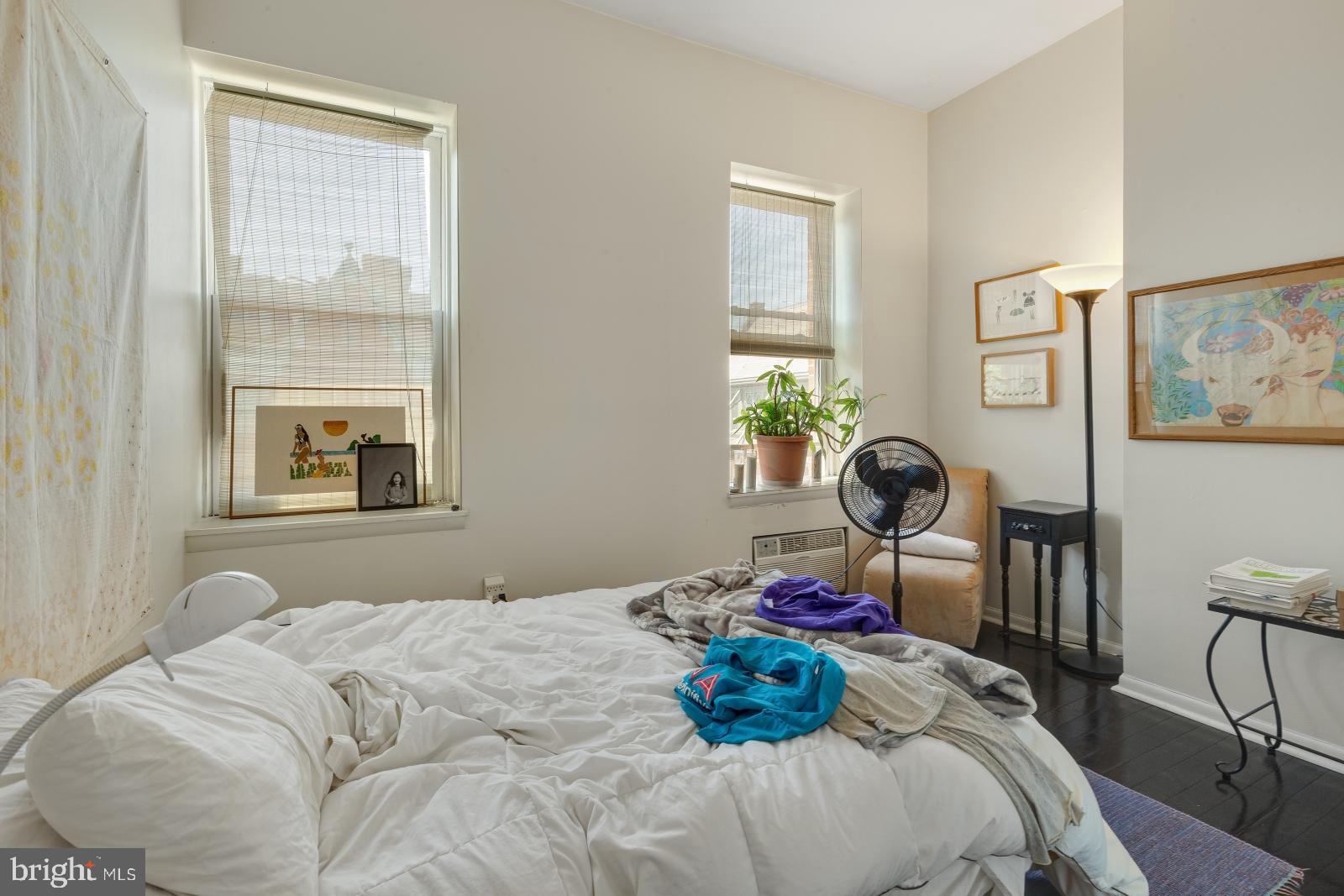 2137 Spruce Street, Unit 8 Philadelphia, PA 19103 - Photo 8 of 12 a bedroom with a bed and windows