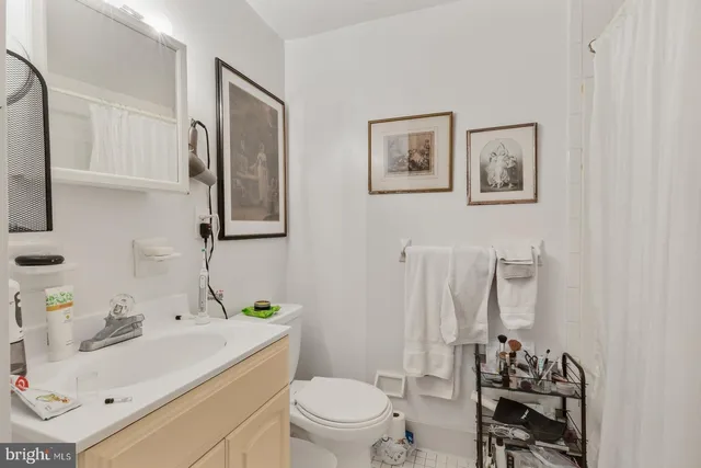 a bathroom with a sink toilet and mirror