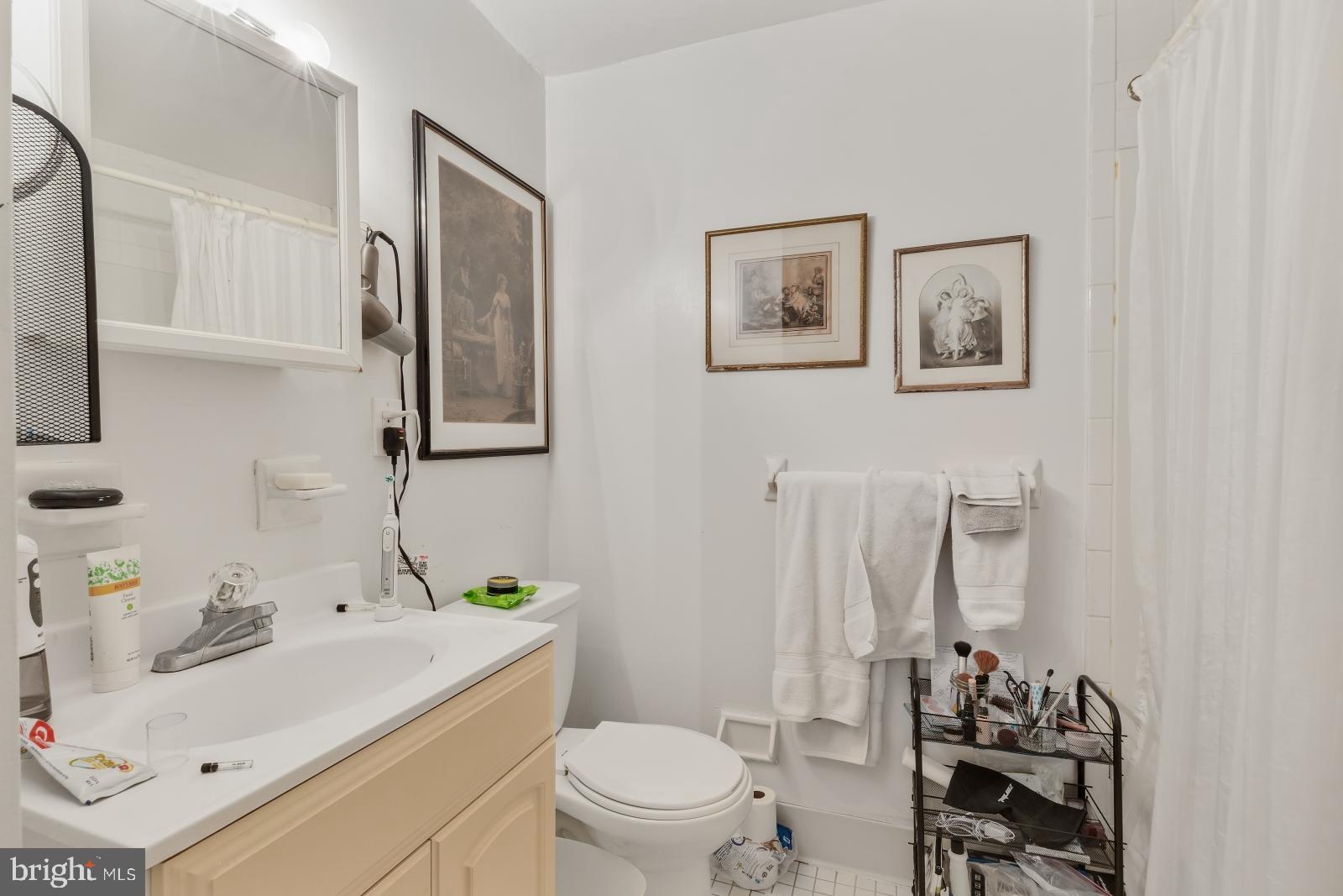 2137 Spruce Street, Unit 8 Philadelphia, PA 19103 - Photo 10 of 12 a bathroom with a sink toilet and mirror