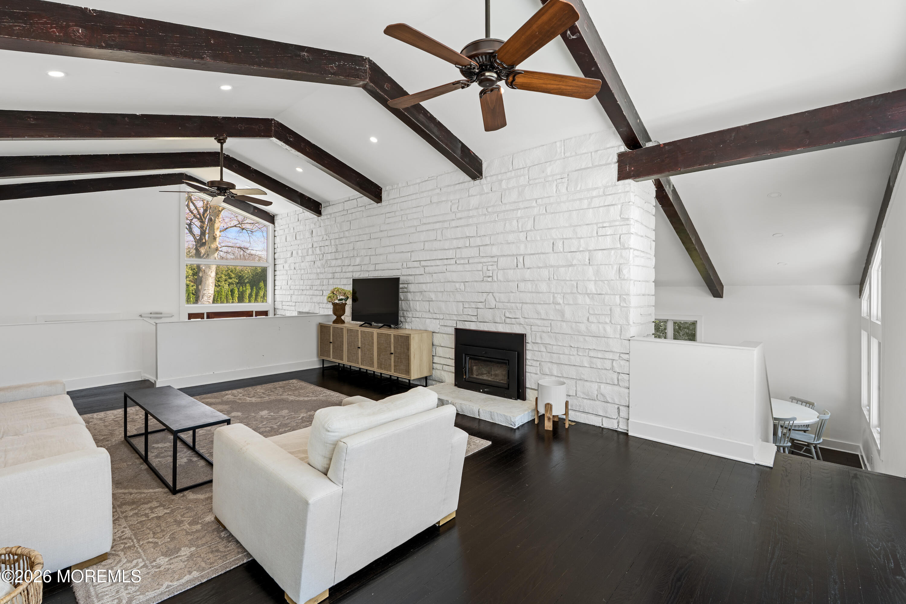 710 Fernmere Avenue Interlaken, NJ 07712 - Photo 15 of 37 a living room with furniture and a fireplace