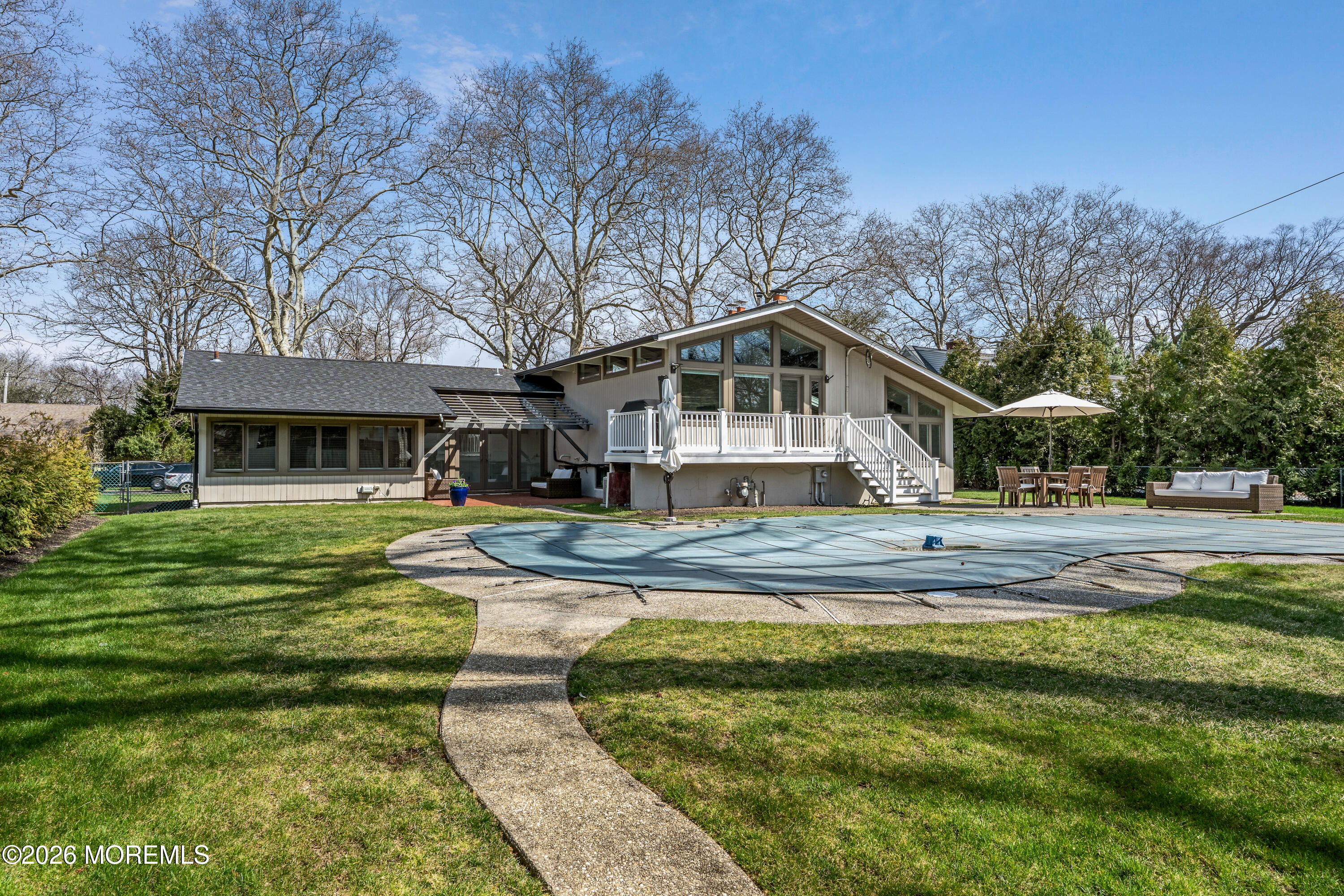 710 Fernmere Avenue Interlaken, NJ 07712 - Photo 2 of 37 a front view of a house with a yard table and chairs