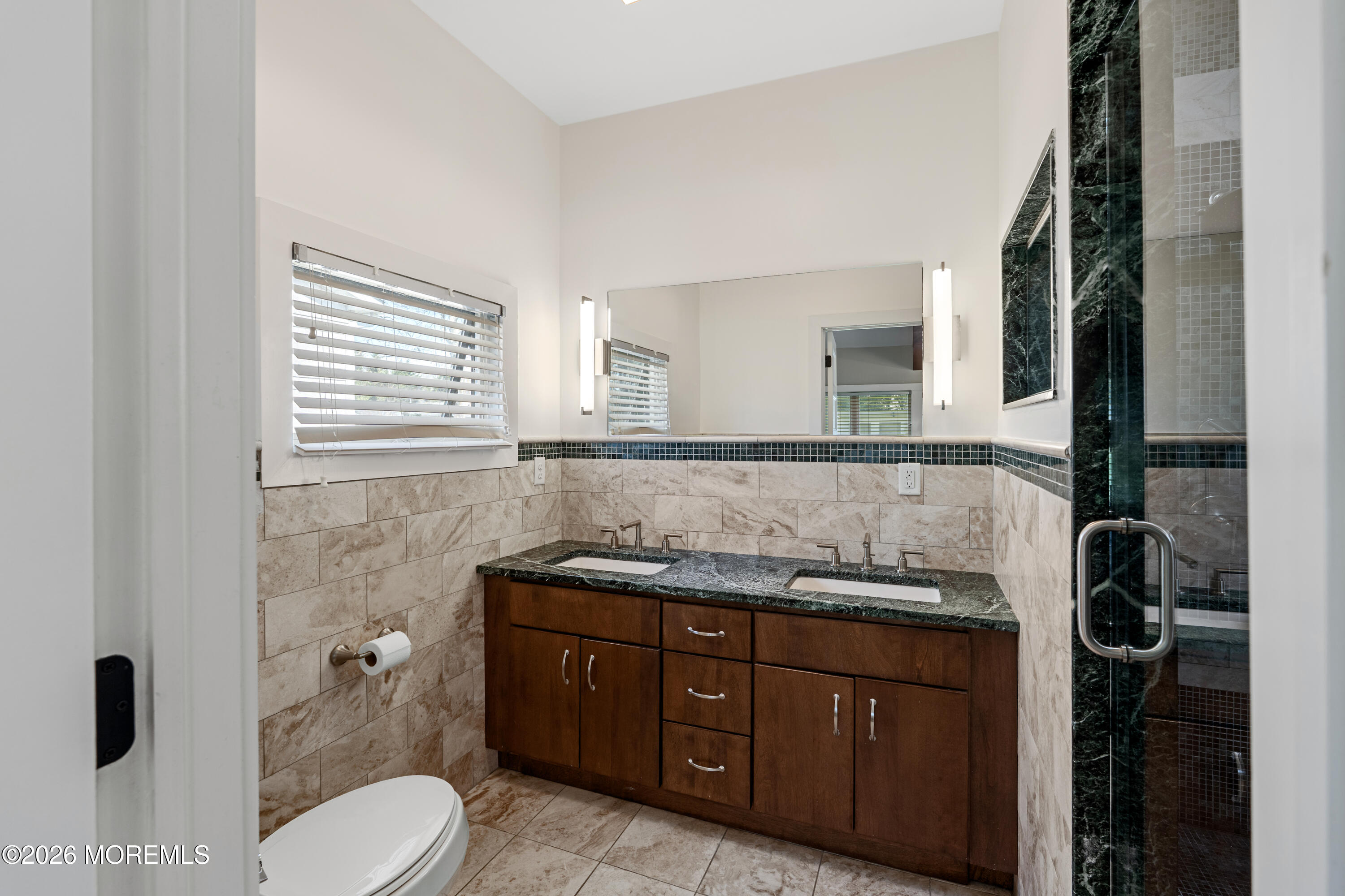 710 Fernmere Avenue Interlaken, NJ 07712 - Photo 21 of 37 a bathroom with a granite countertop sink toilet and mirror