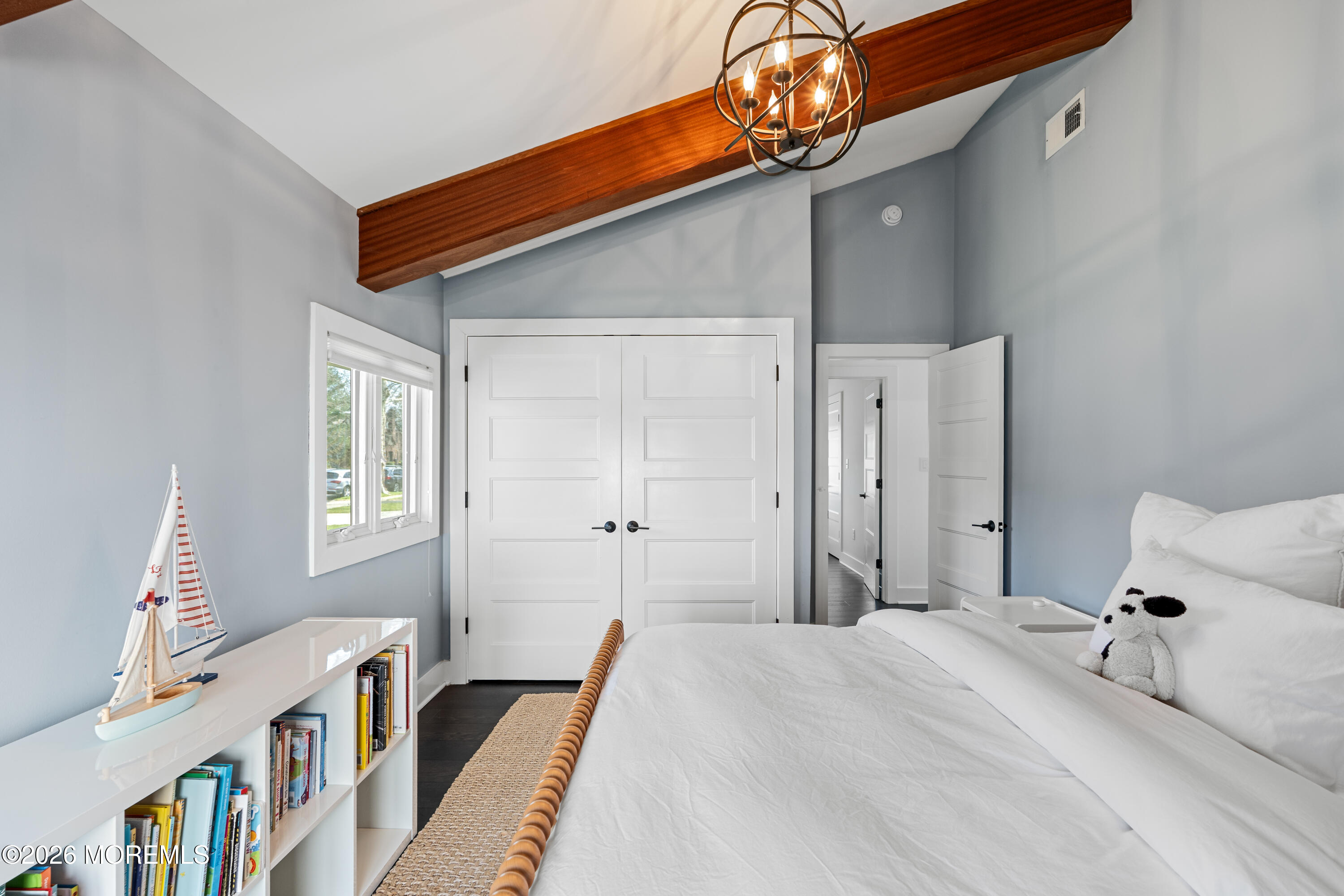 710 Fernmere Avenue Interlaken, NJ 07712 - Photo 25 of 37 a bedroom with a bed and a book shelf