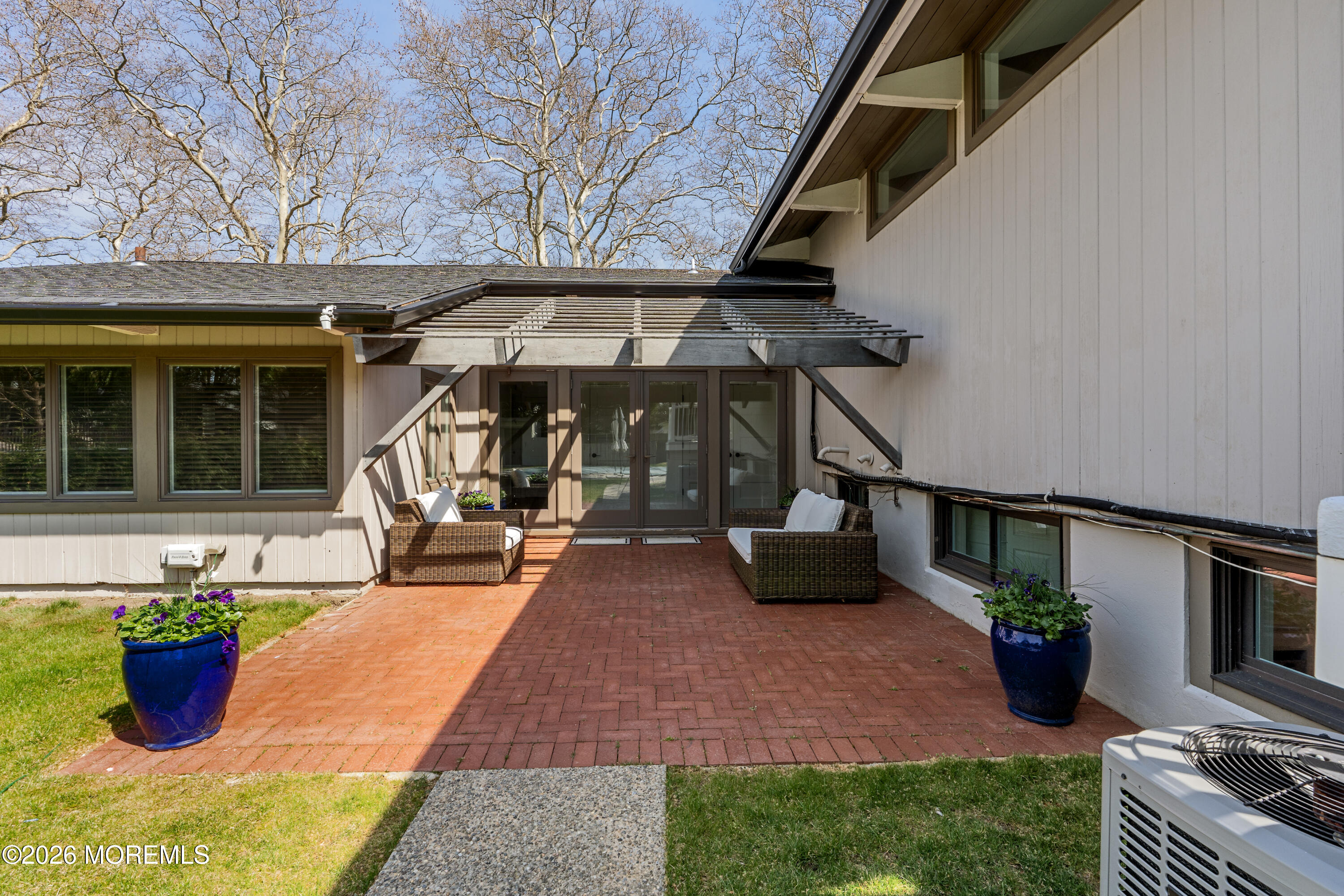 710 Fernmere Avenue Interlaken, NJ 07712 - Photo 32 of 37 a view of a patio with table and chairs potted plants and a barbeque