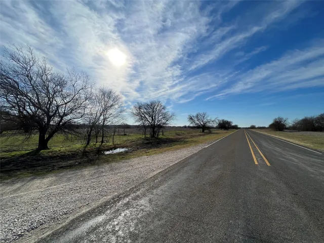 a view of a street with a yard