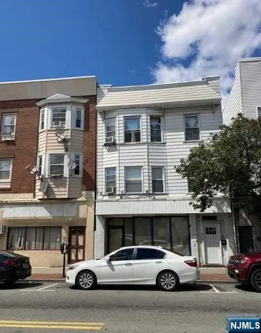 a view of a cars park in front of a building