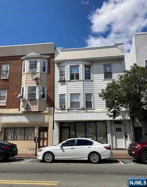 304 Harrison Avenue, Unit 1) Harrison, NJ 07029 - Photo 1 of 10 a view of a cars park in front of a building