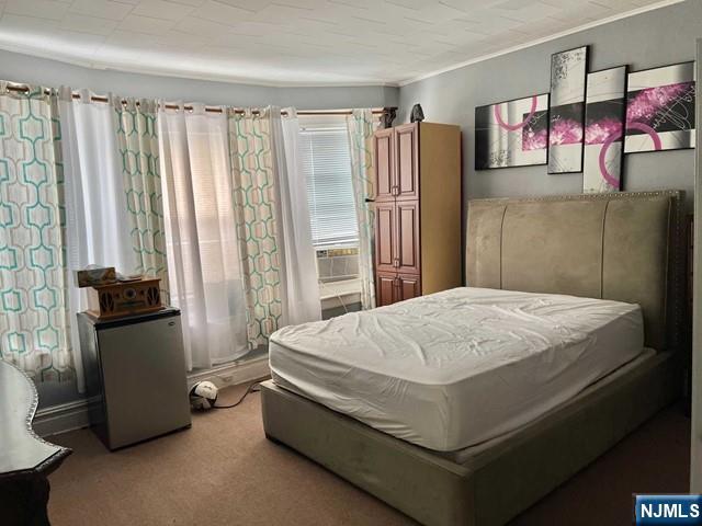 304 Harrison Avenue, Unit 1) Harrison, NJ 07029 - Photo 11 of 15 a bed sitting in a bedroom next to a window