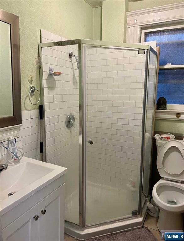 304 Harrison Avenue, Unit 1) Harrison, NJ 07029 - Photo 15 of 15 a bathroom with a granite countertop toilet sink and shower