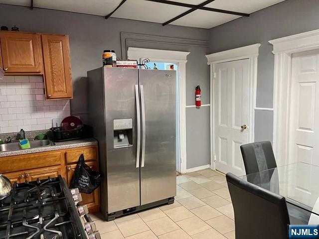 304 Harrison Avenue, Unit 1) Harrison, NJ 07029 - Photo 5 of 10 a metallic refrigerator freezer sitting in a kitchen