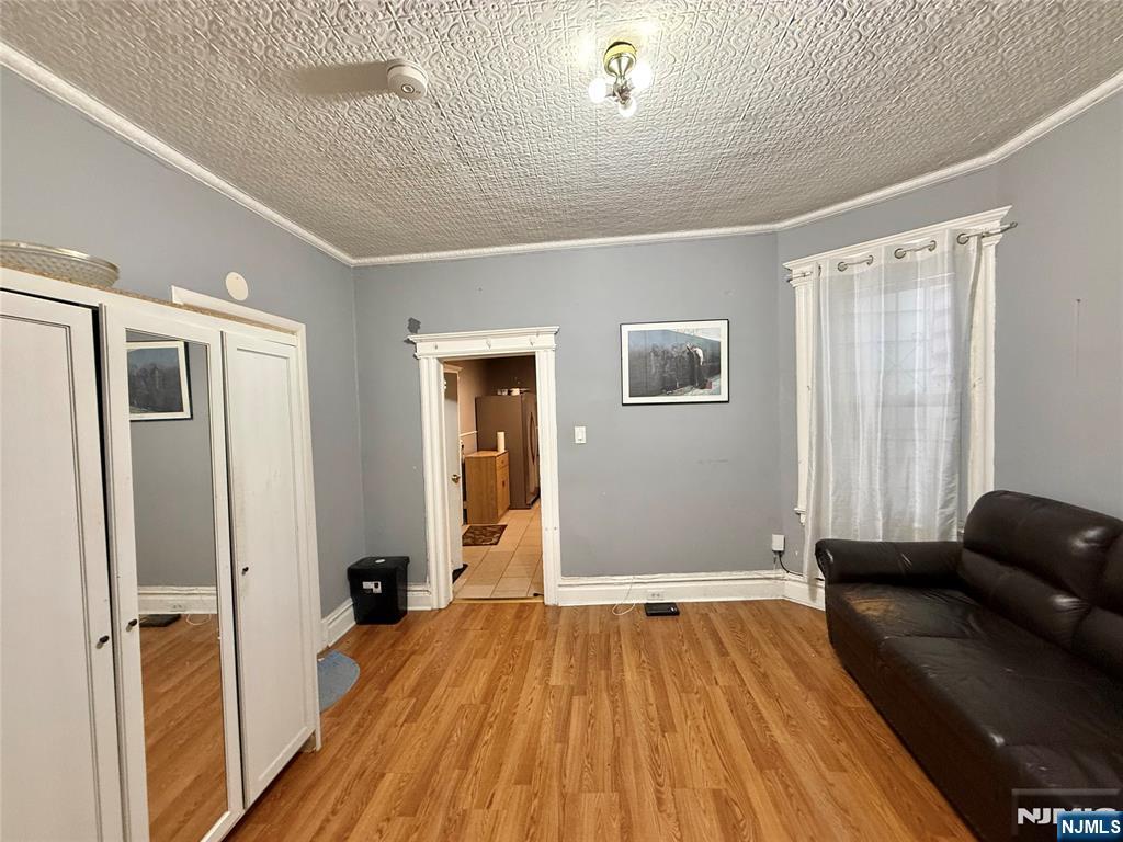 304 Harrison Avenue, Unit 1) Harrison, NJ 07029 - Photo 6 of 15 a view of livingroom with hardwood floor and hallway