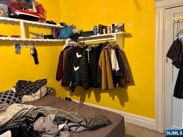 304 Harrison Avenue, Unit 1) Harrison, NJ 07029 - Photo 8 of 10 a bed sitting in a bedroom next to a window