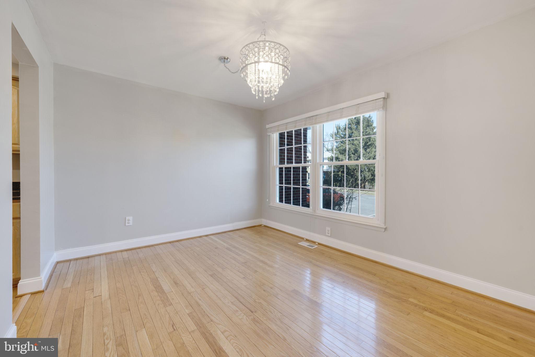 6457 Rockshire Street Alexandria, VA 22315 - Photo 4 of 26 a view of an empty room with wooden floor and a window
