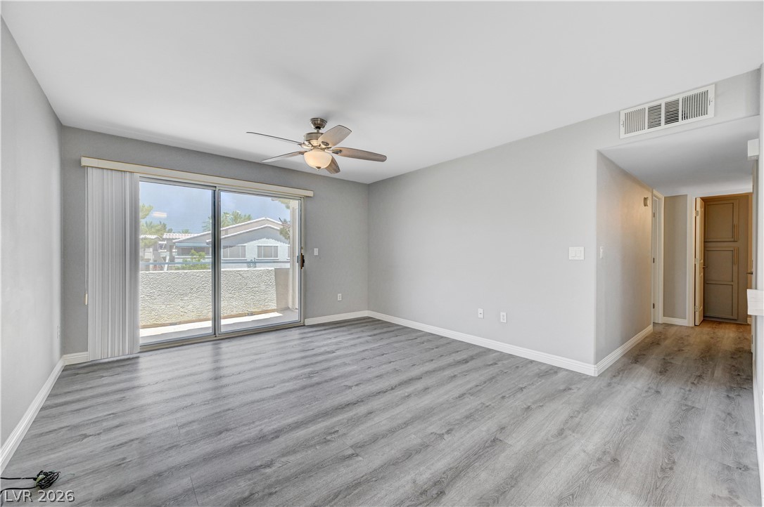 3425 East Russell Road, Unit 223 Las Vegas, NV 89120 - Photo 12 of 47 A sliding glass door opens to a spacious balcony, offering an inviting outdoor retreat.