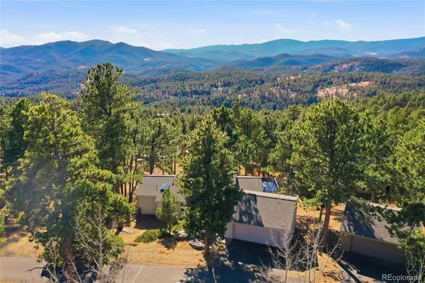 an aerial view of a house with mountain view