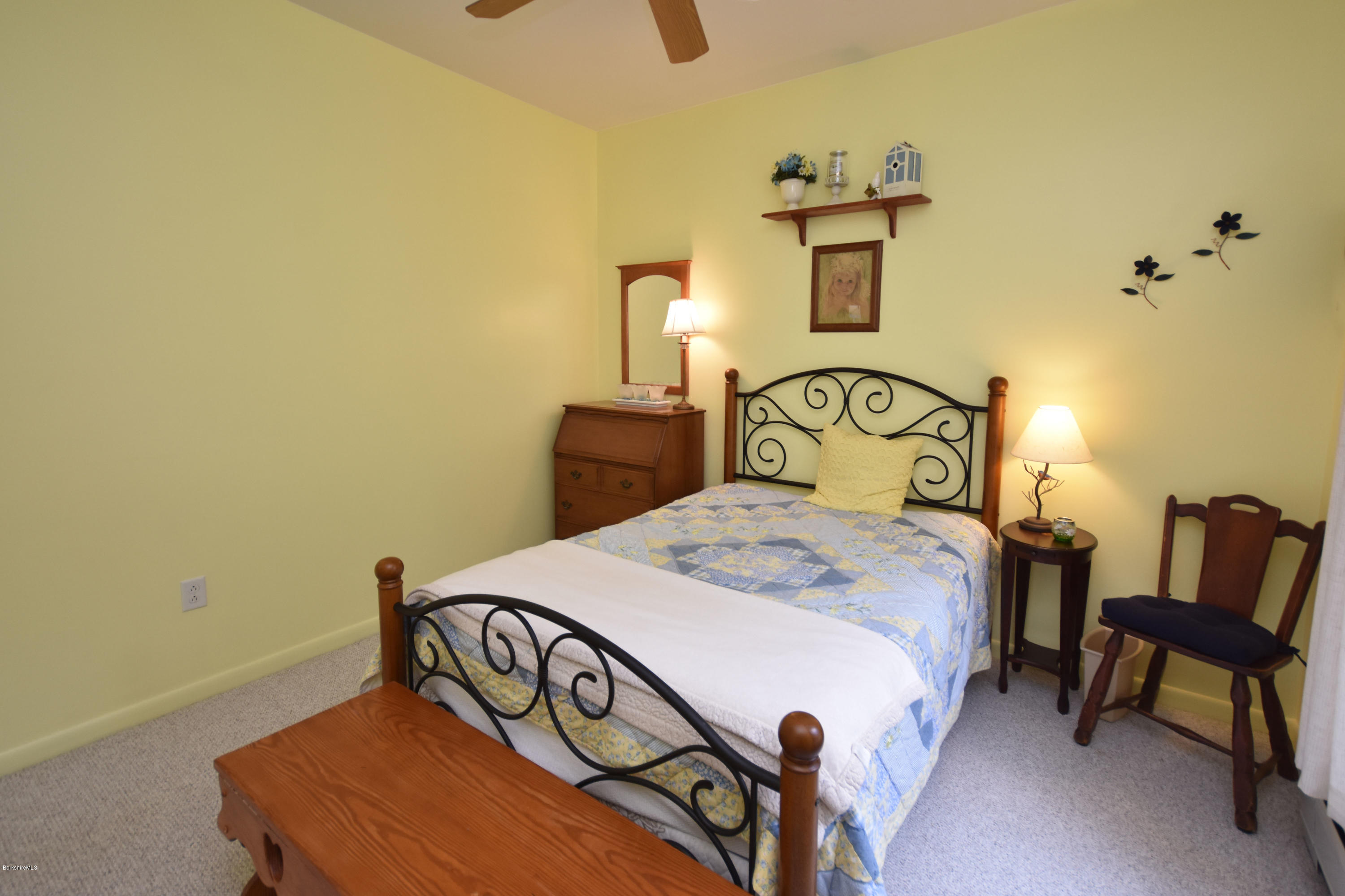 555 West Center Road Otis, MA 01253 - Photo 34 of 49 a bedroom with a bed a table and chair