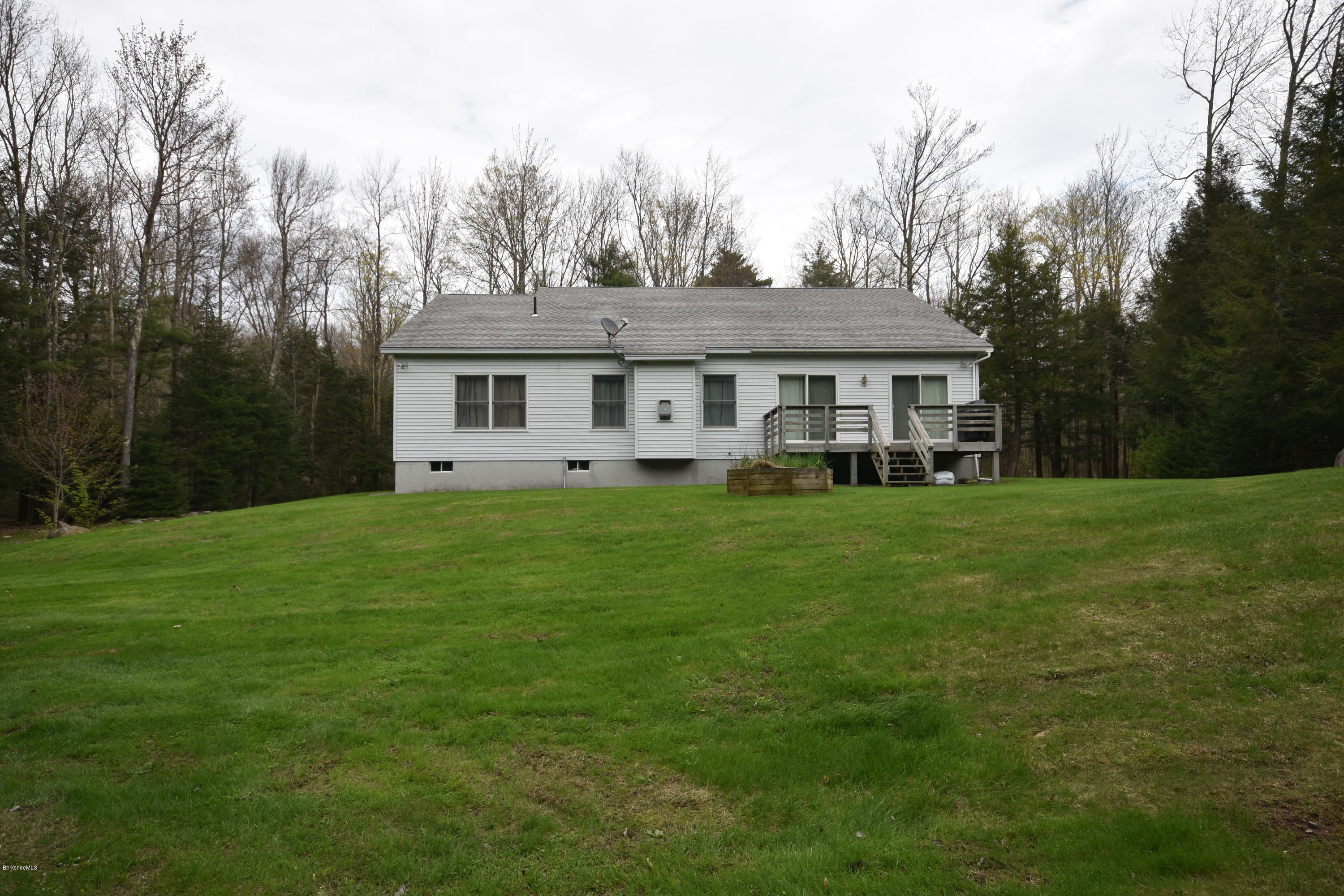 555 West Center Road Otis, MA 01253 - Photo 44 of 49 a front view of house with yard and green space