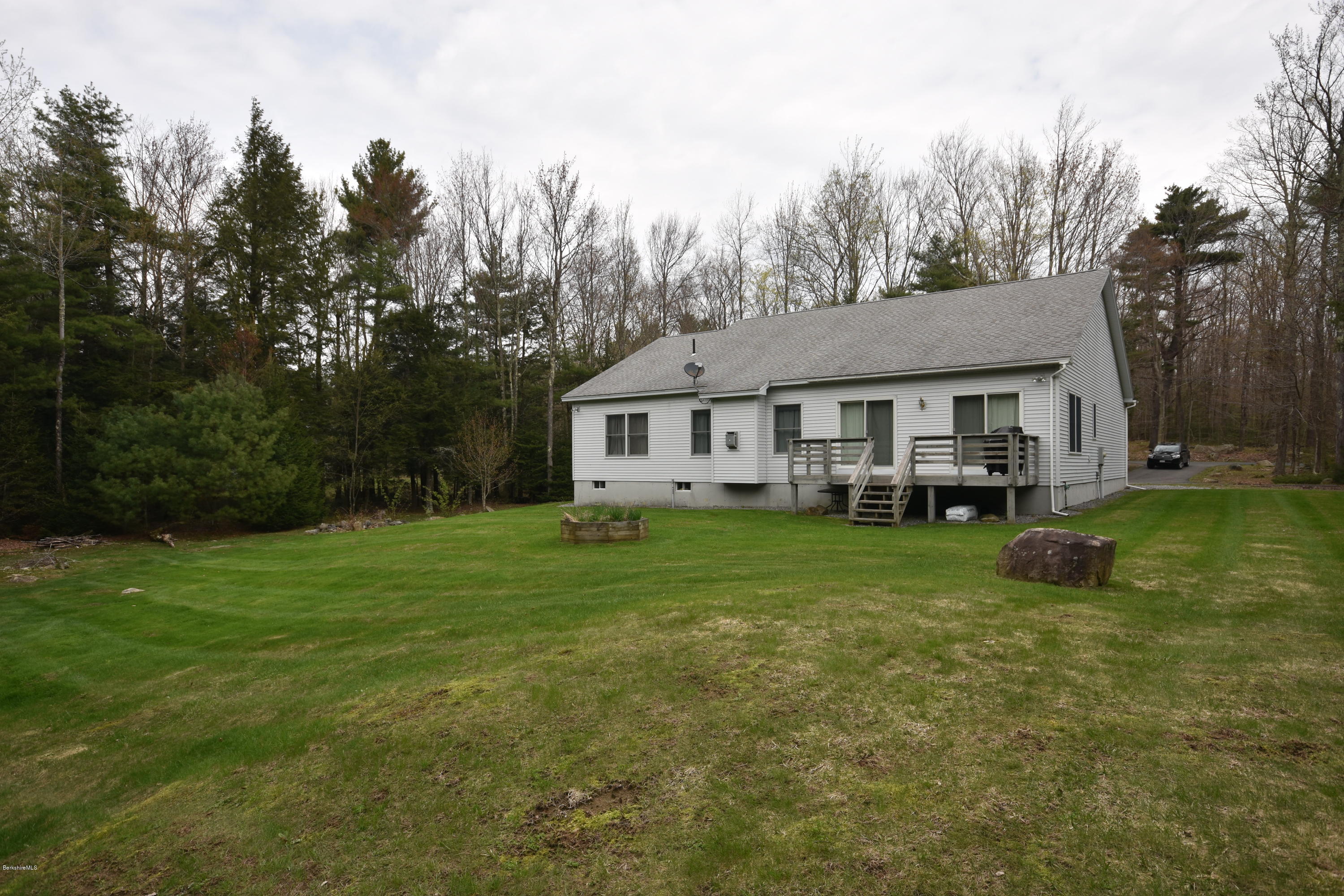 555 West Center Road Otis, MA 01253 - Photo 45 of 49 a view of a house with a yard deck and sitting area