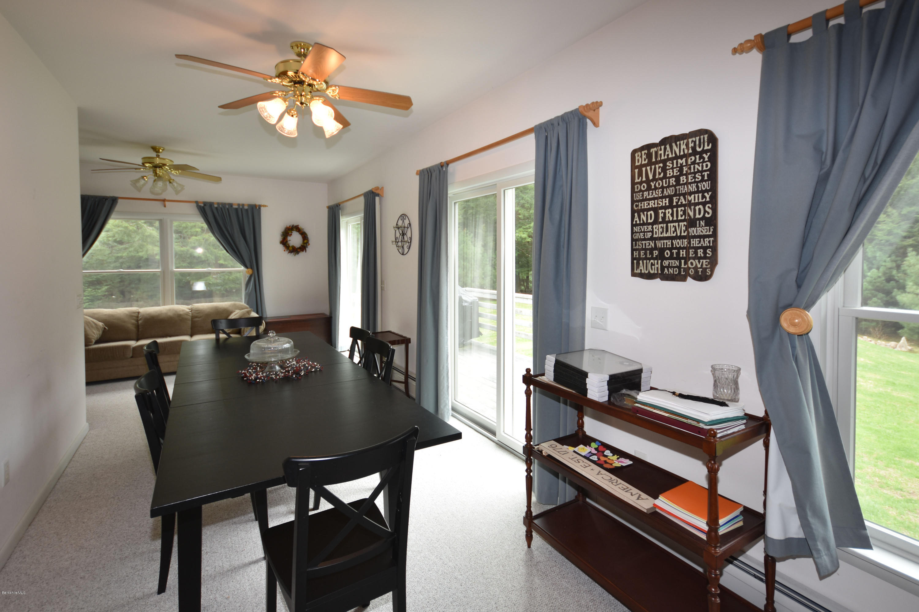 555 West Center Road Otis, MA 01253 - Photo 10 of 49 a view of a dining room with furniture and a chandelier