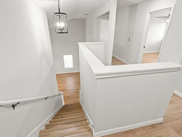 a view of an empty room and wooden floor
