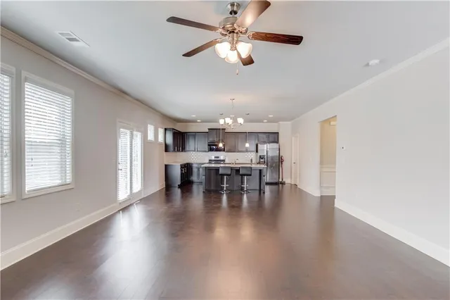 a view of a dining room with furniture and a chandelier