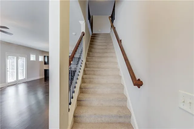 a view of staircase with lots of frames and wooden floor