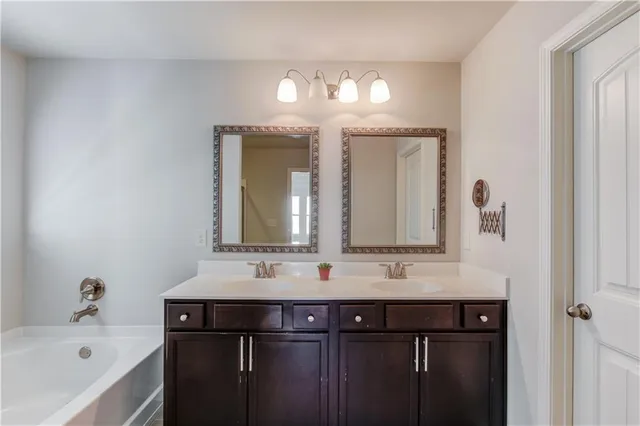 a bathroom with a double vanity sink and mirror