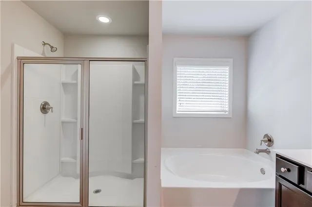 a bathroom with a bathtub and a shower