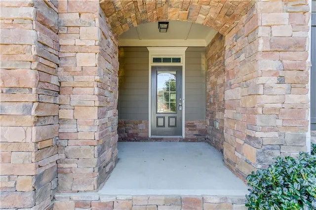 a view of a brick house with a large window