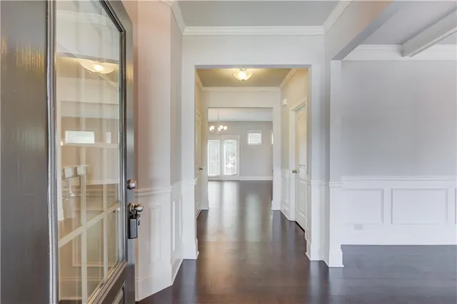 a view of a hallway with wooden floor and closet