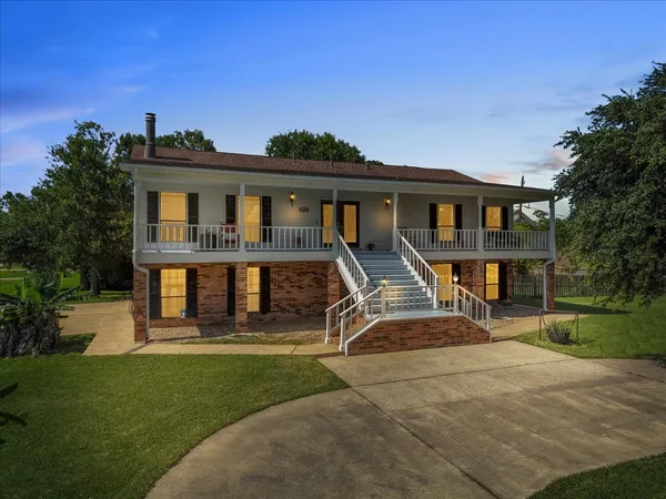 a view of a house with a yard porch and sitting area