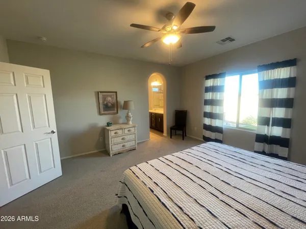 a bedroom with furniture and a chandelier