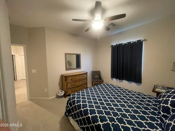 a bedroom with a bed and a lamp