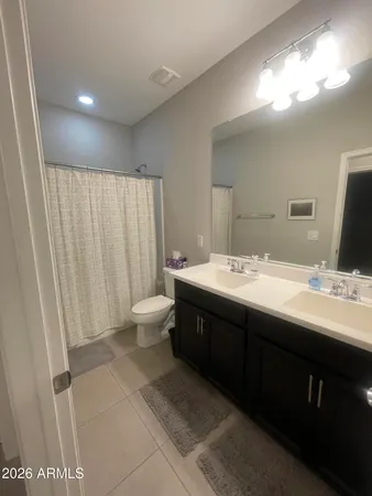 a bathroom with a double vanity sink and a mirror