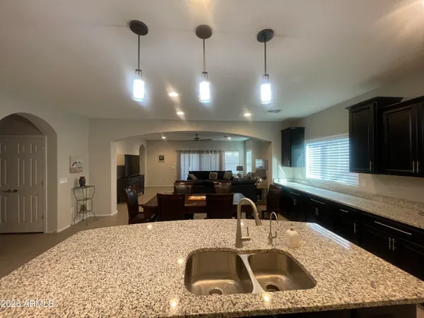 a kitchen with a sink a counter and chairs