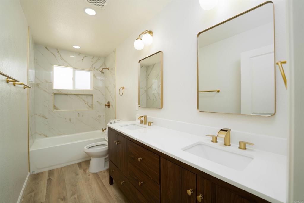 1314 Bluegrass Road Vista, CA 92083 - Photo 14 of 16 a bathroom with a sink a toilet and shower