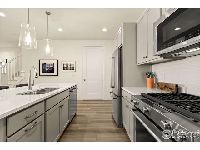 a kitchen with a sink stove and cabinets