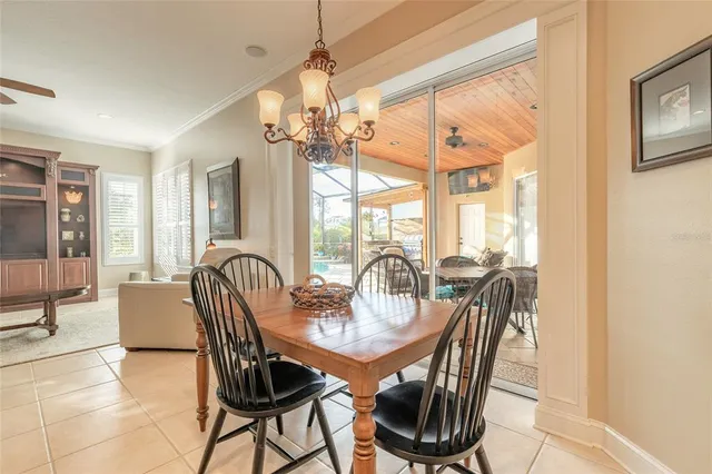 a living room with furniture kitchen view and a chandelier