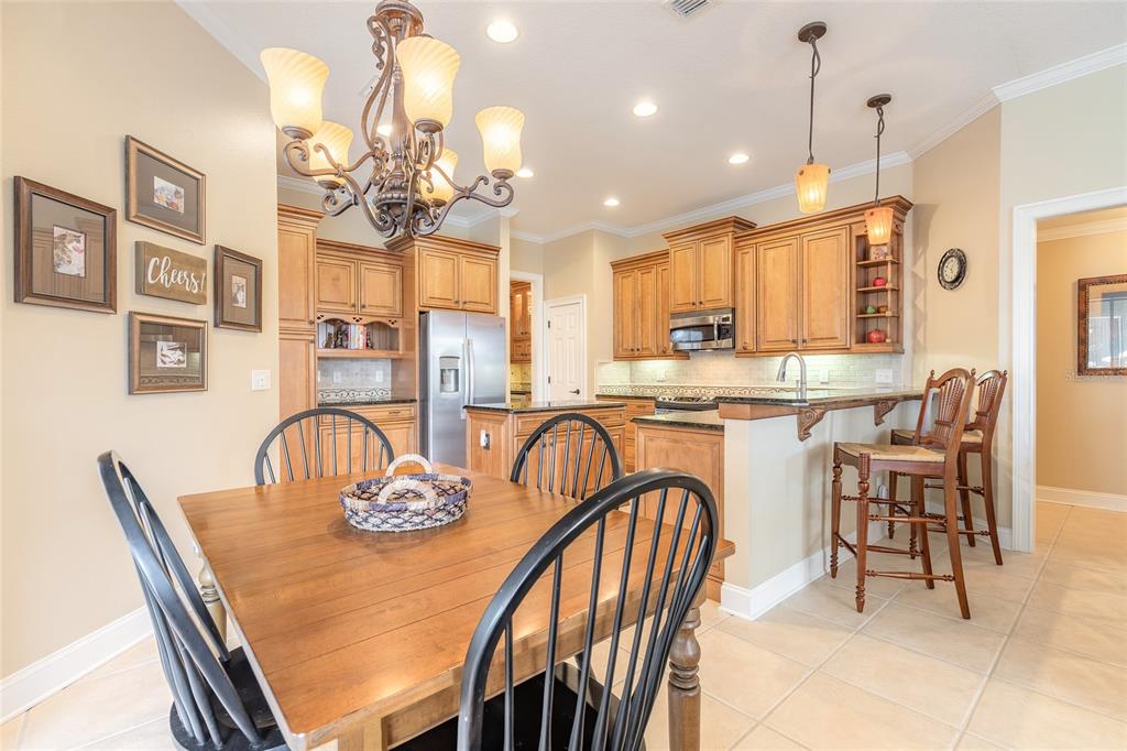 10915 Ledgement Lane Windermere, FL 34786 - Photo 21 of 60 a dining room filled chandelier and wooden furniture