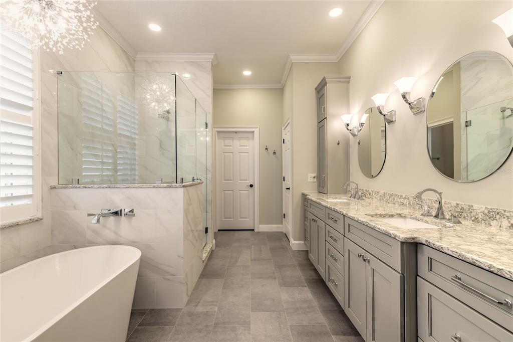 10915 Ledgement Lane Windermere, FL 34786 - Photo 27 of 60 a spacious bathroom with a double vanity sink mirror double and bathtub